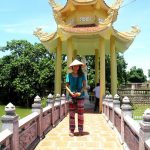 Student standing in fron of pagoda in Vietnam.